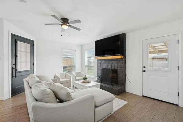 a living room with furniture a fireplace and a flat screen tv