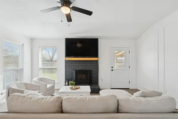 a living room with furniture fireplace and window