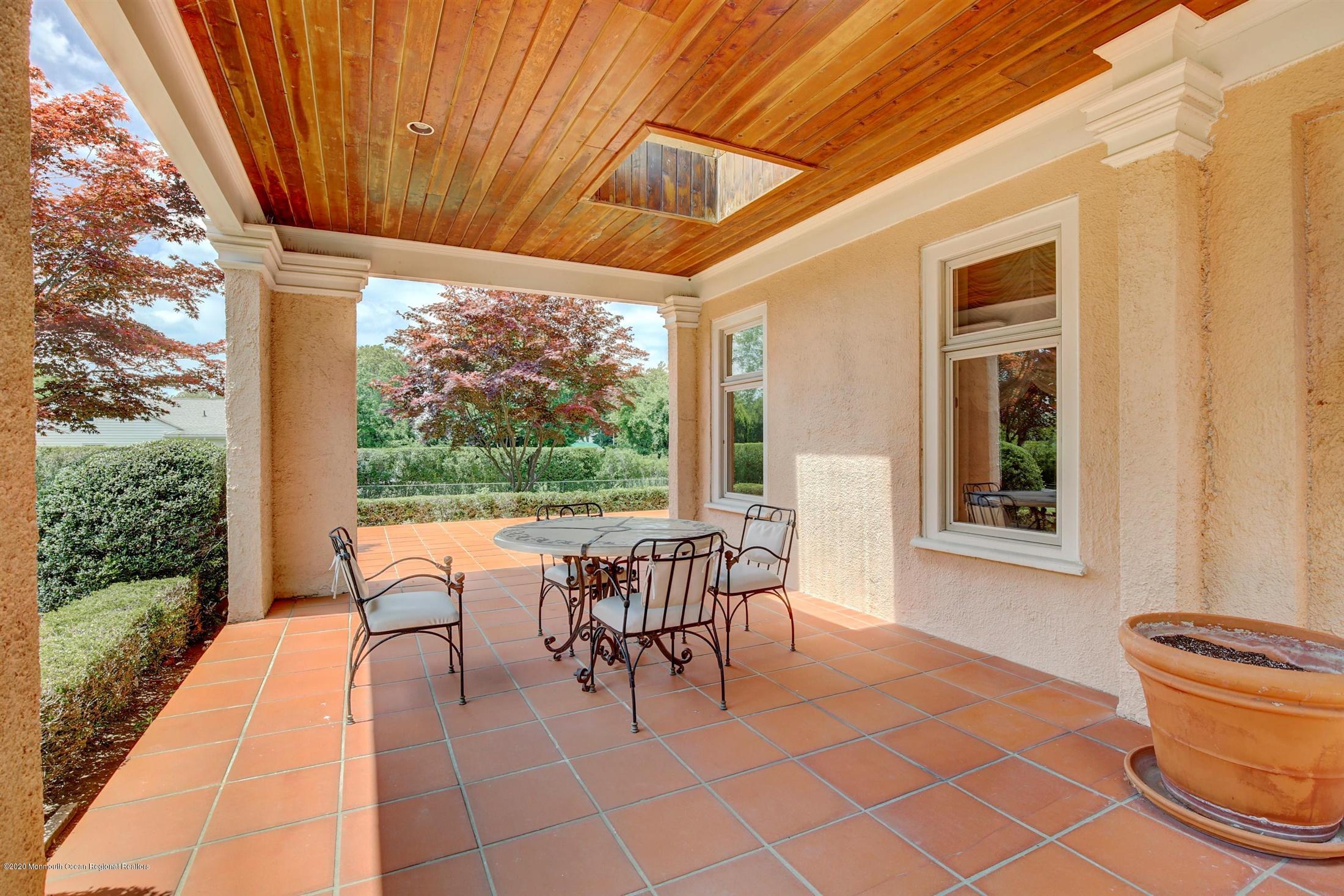 45 Runyan Avenue Deal, NJ 07723 - Photo 12 of 60 a balcony with chairs and a table