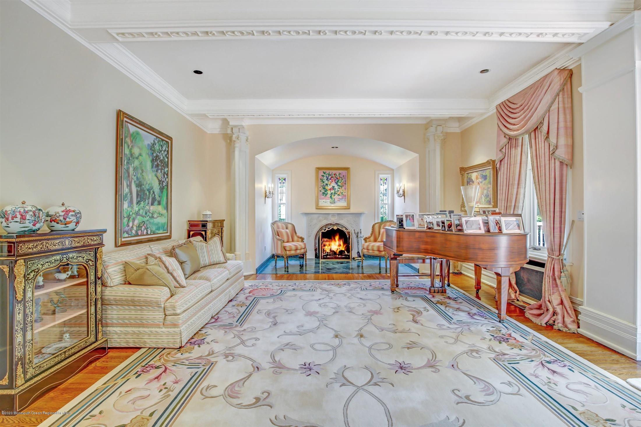45 Runyan Avenue Deal, NJ 07723 - Photo 28 of 60 a living room with furniture a fireplace and a table with wooden floor