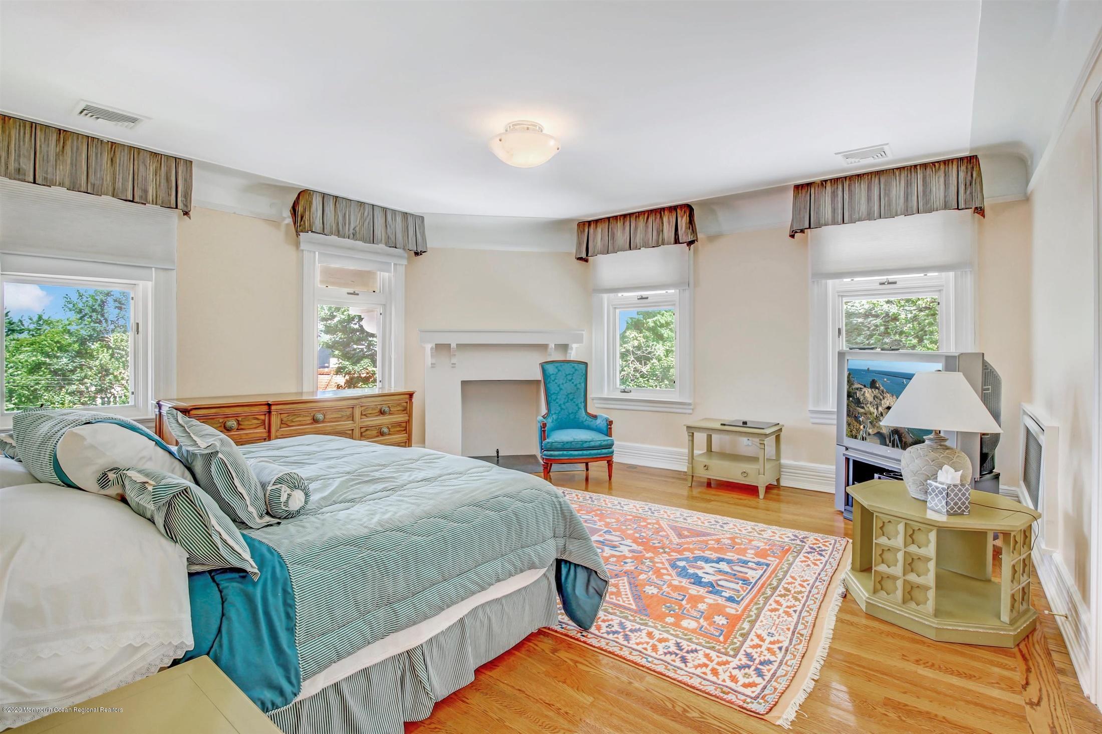 45 Runyan Avenue Deal, NJ 07723 - Photo 37 of 60 a bedroom with a bed a table and chair with the wooden floor