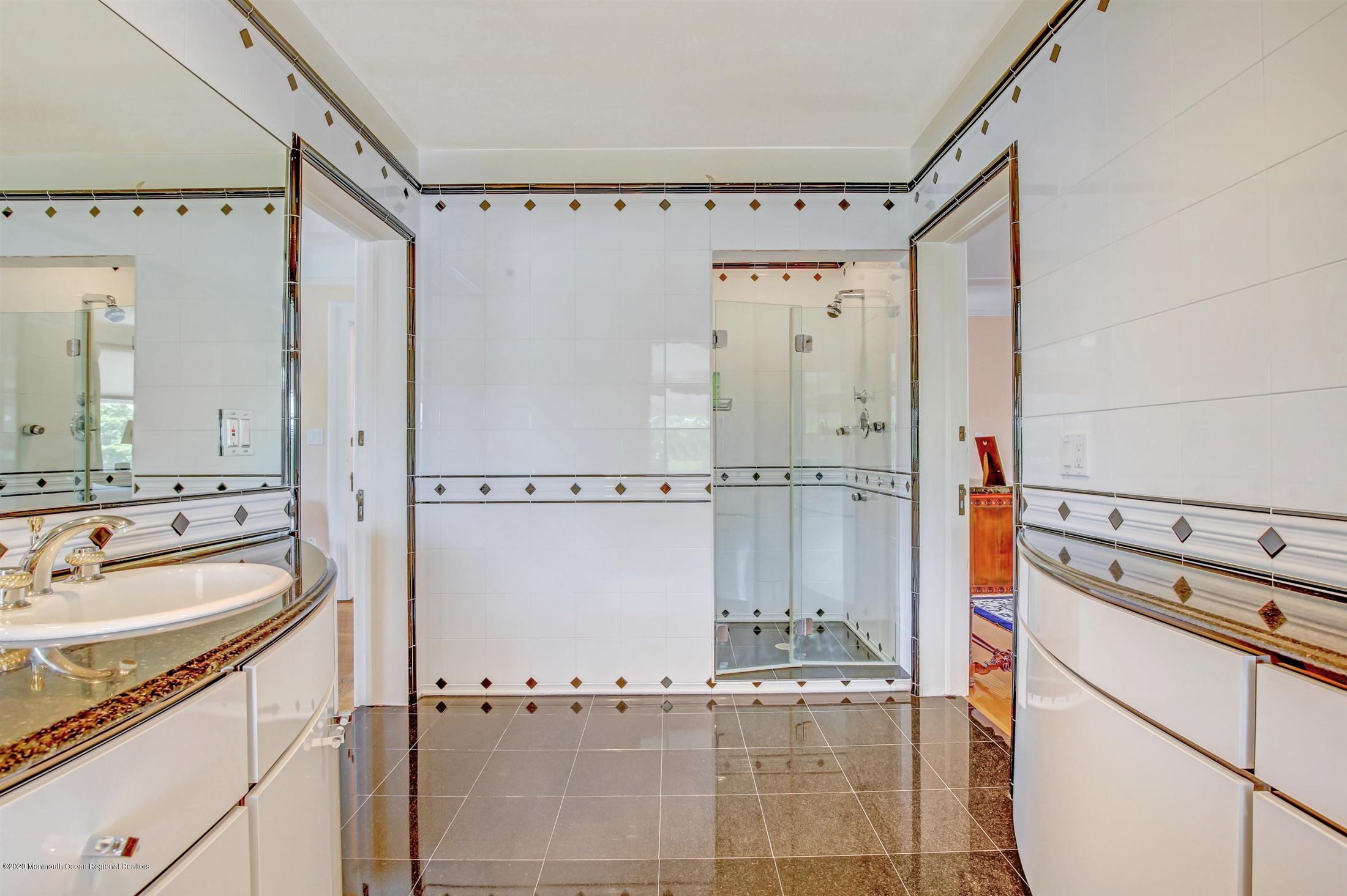 45 Runyan Avenue Deal, NJ 07723 - Photo 39 of 60 a bathroom with a tub a sink and mirror