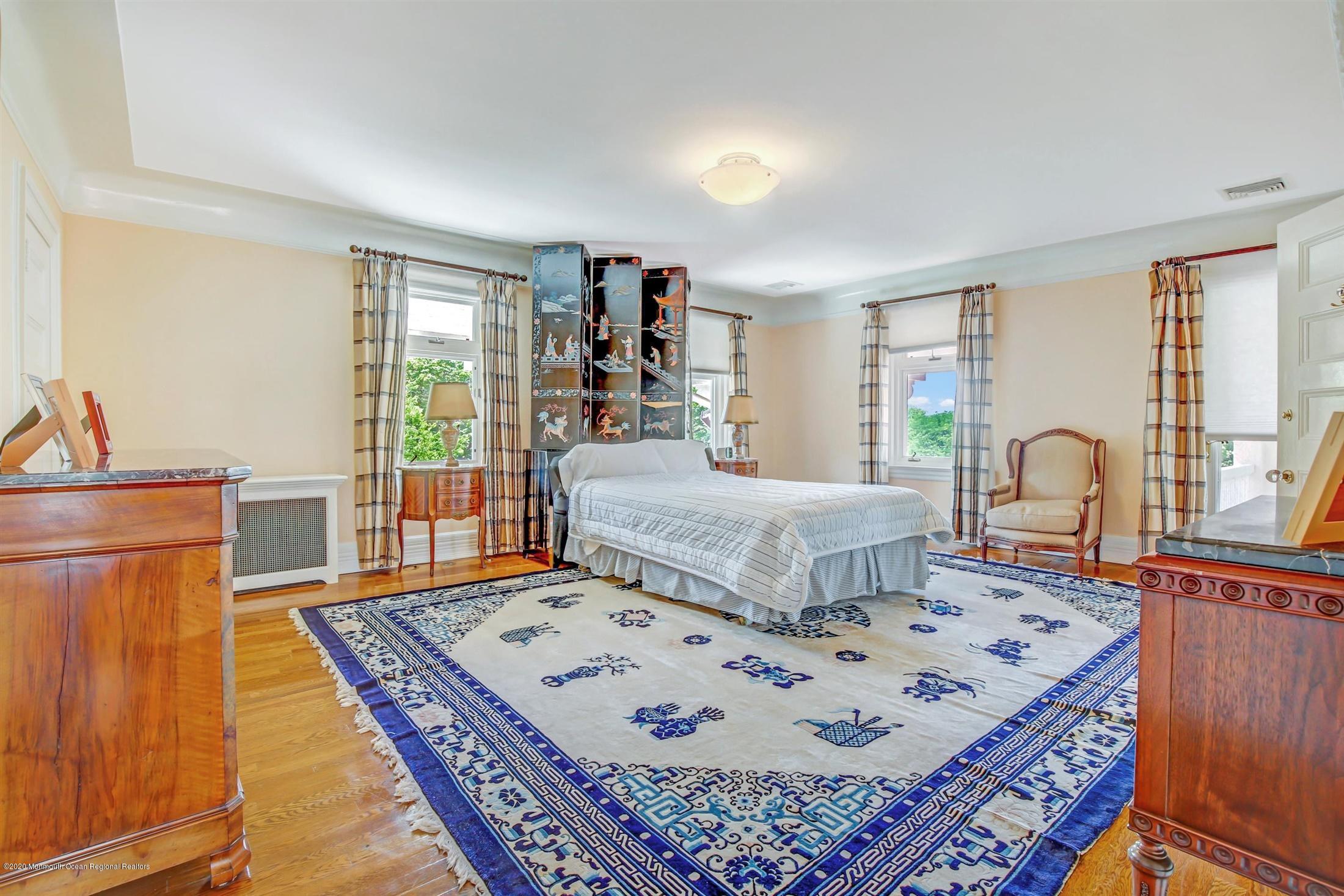 45 Runyan Avenue Deal, NJ 07723 - Photo 41 of 60 a bedroom with a bed a table and large windows