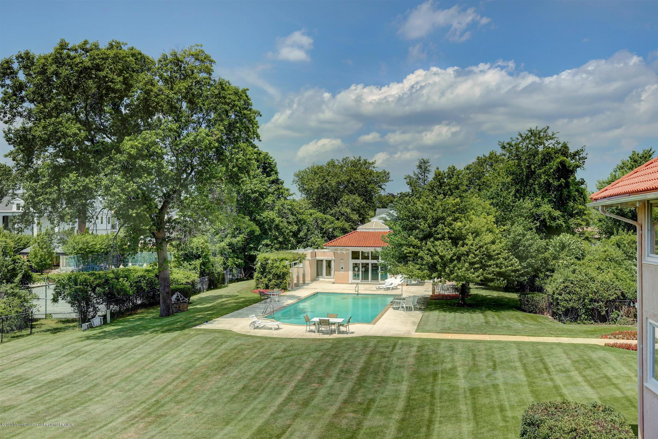 45 Runyan Avenue Deal, NJ 07723 - Photo 45 of 60 a view of a swimming pool with a yard
