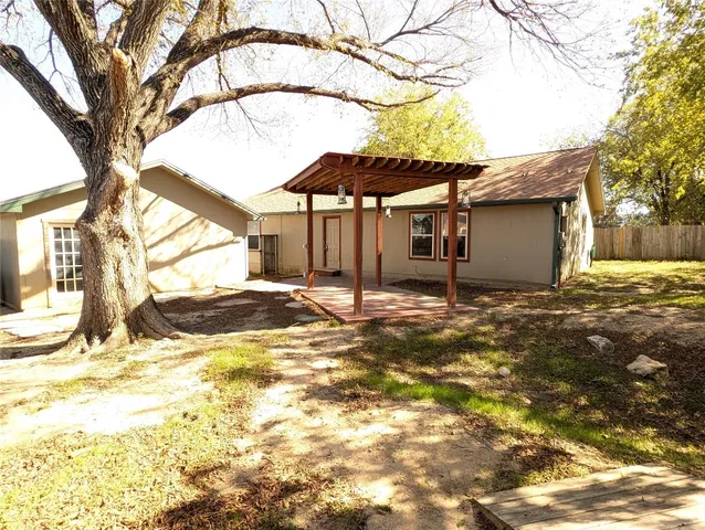 a view of yard with wooden fence