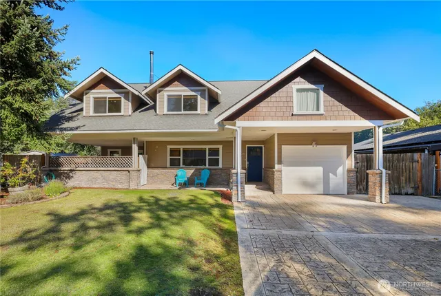 a front view of a house with swimming pool and porch