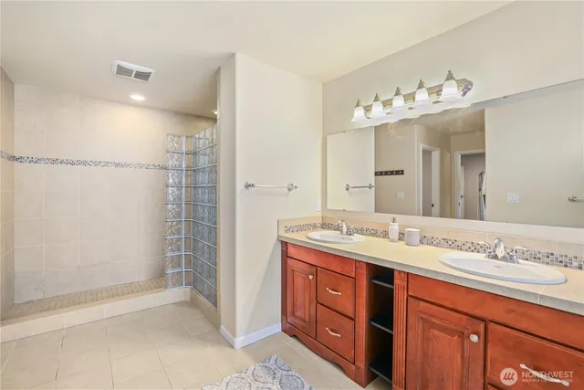 a spacious bathroom with a double vanity sink mirror and double