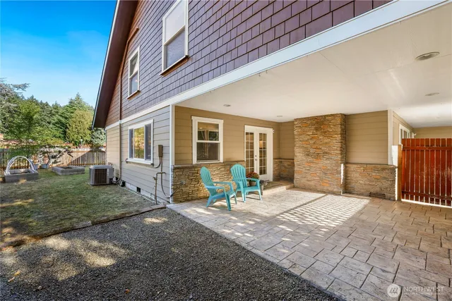 a view of a house with backyard porch and sitting area