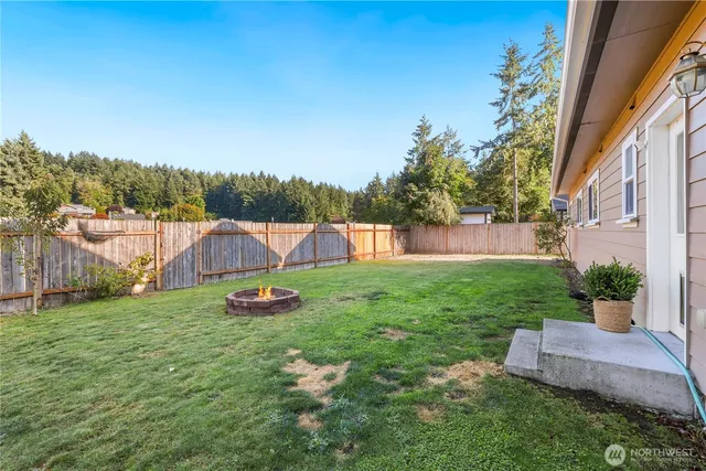 a view of a backyard with plants and a slide
