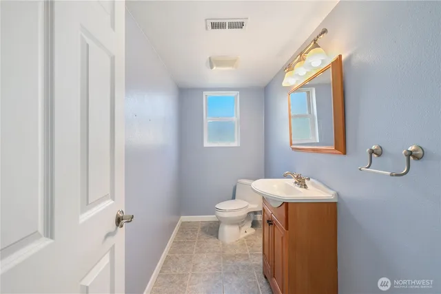 a bathroom with a sink toilet and mirror