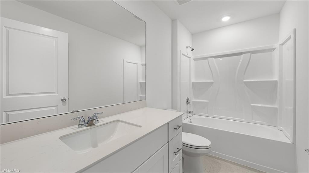 3717 23rd Street Southwest Lehigh Acres, FL 33976 - Photo 8 of 26 a bathroom with a sink a toilet and shower