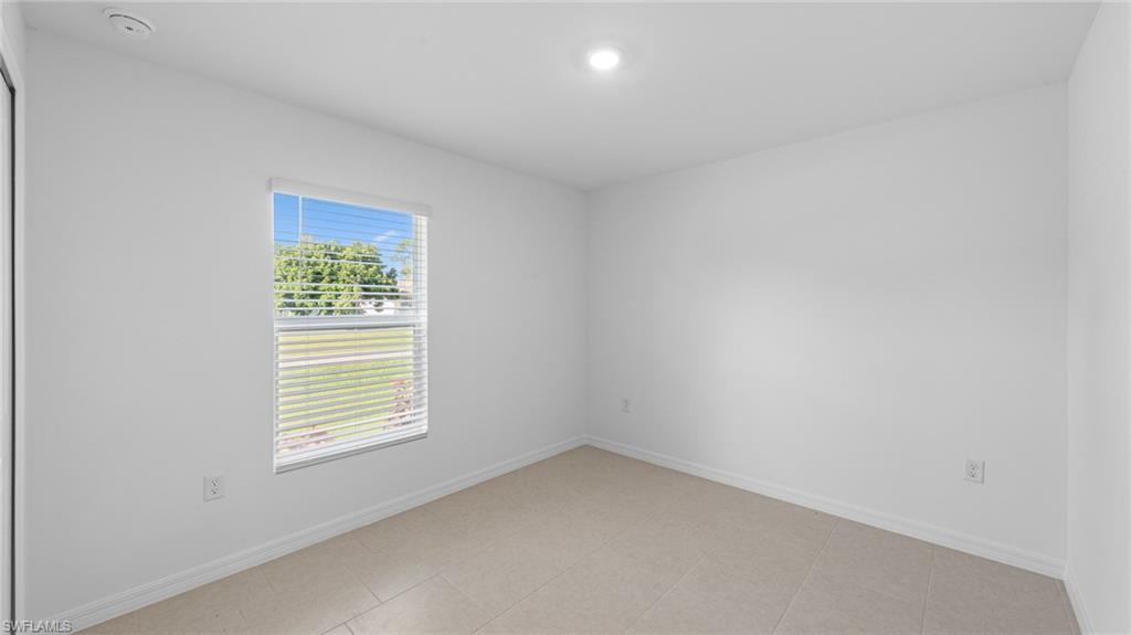 3717 23rd Street Southwest Lehigh Acres, FL 33976 - Photo 9 of 26 an empty room with a window