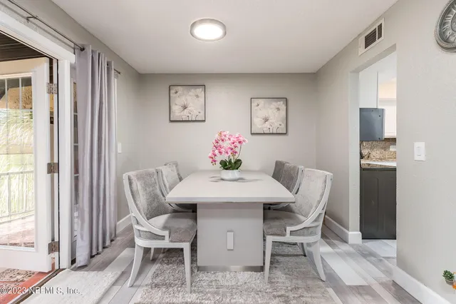 a view of a dining room with furniture and a window