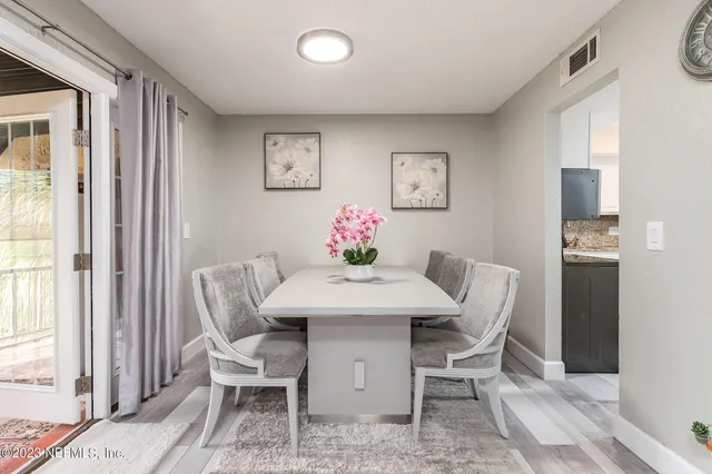 a view of a dining room with furniture and a window