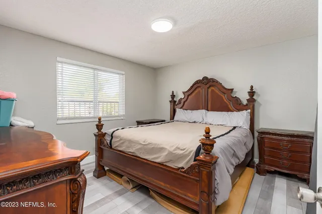 a bed sitting in a bedroom next to a window