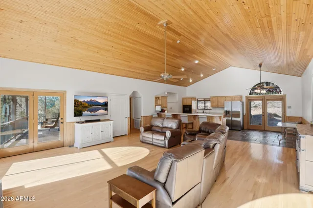 a open kitchen with stainless steel appliances granite countertop a refrigerator a stove a sink dishwasher with a dining table and chairs