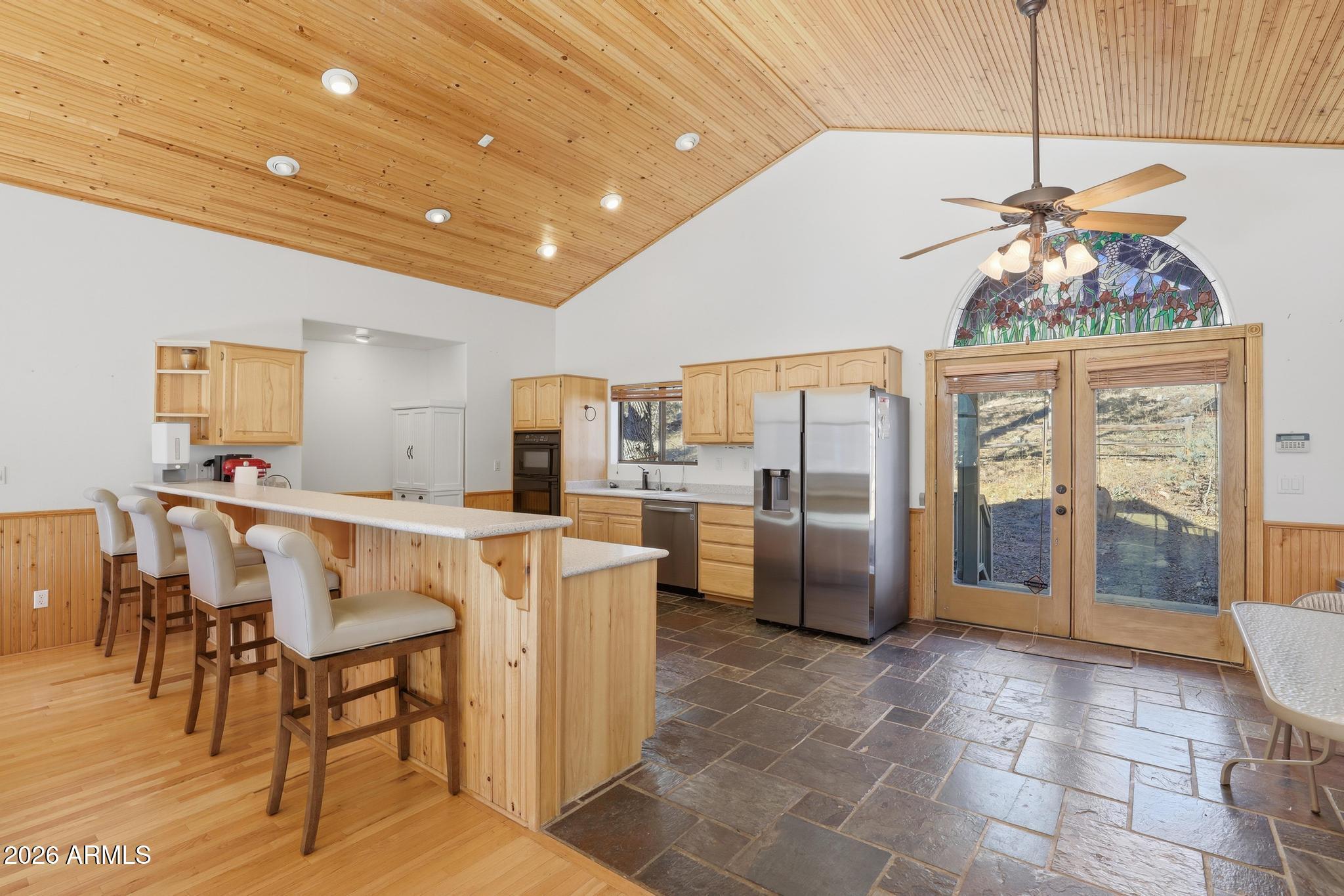 178 Memory Lane Payson, AZ 85541 - Photo 21 of 58 a open kitchen with stainless steel appliances granite countertop a refrigerator a stove a sink dishwasher with a dining table and chairs