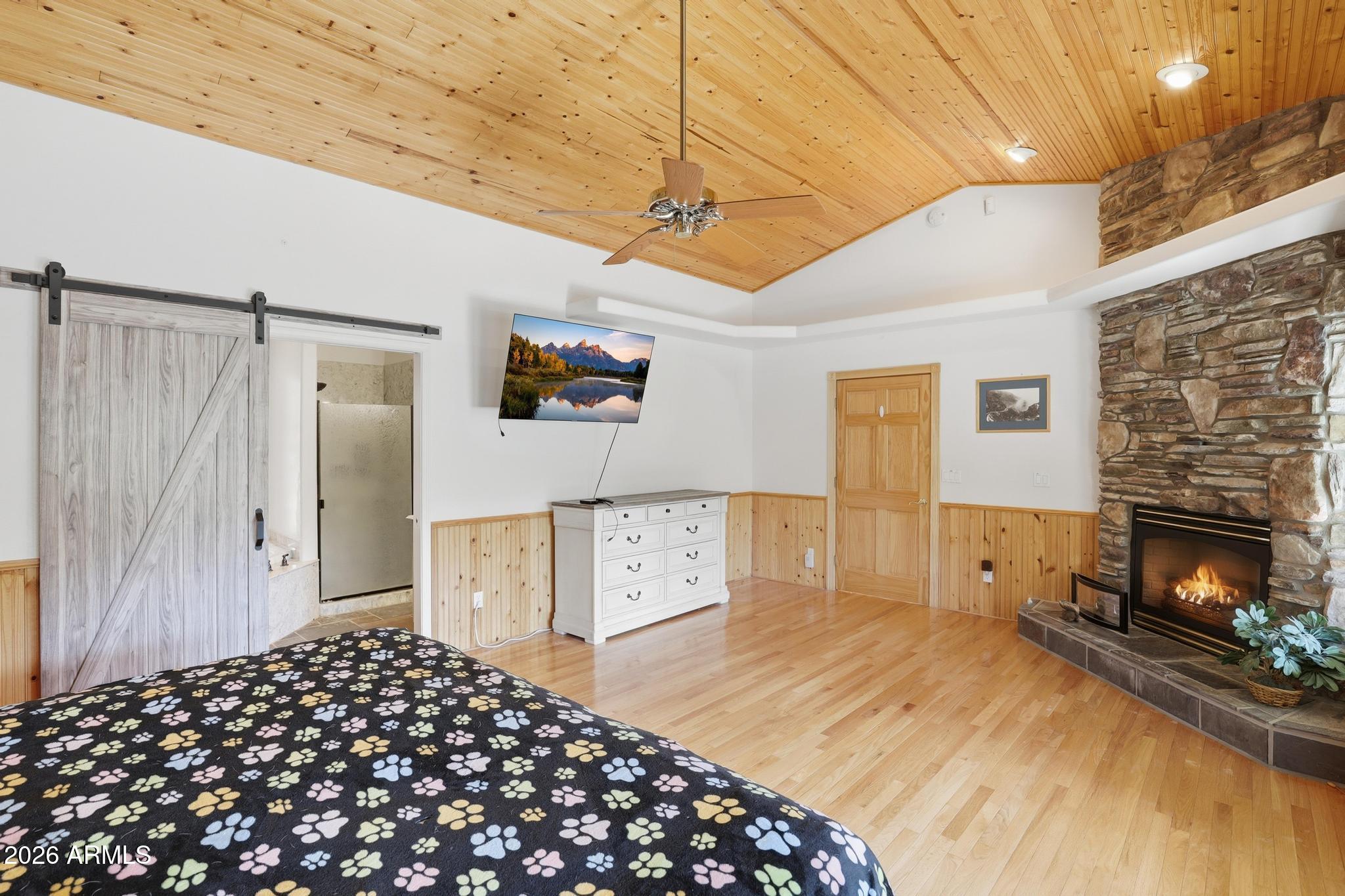 178 Memory Lane Payson, AZ 85541 - Photo 28 of 58 a bedroom with a bed and a fireplace