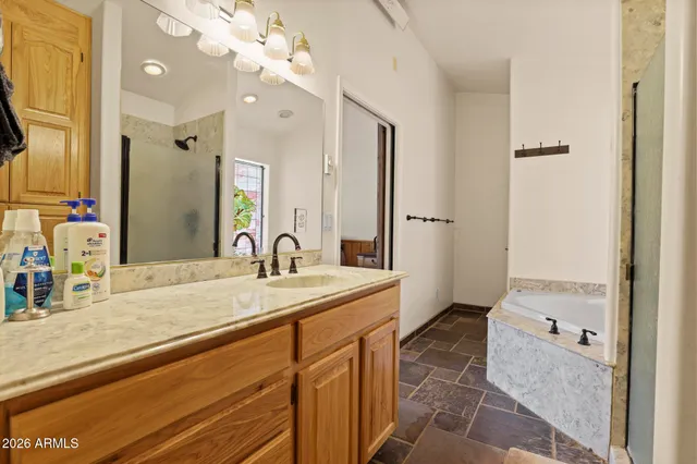 a bathroom with a double vanity sink toilet mirror and shower