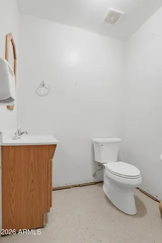 a view of a house with a yard and wooden fence