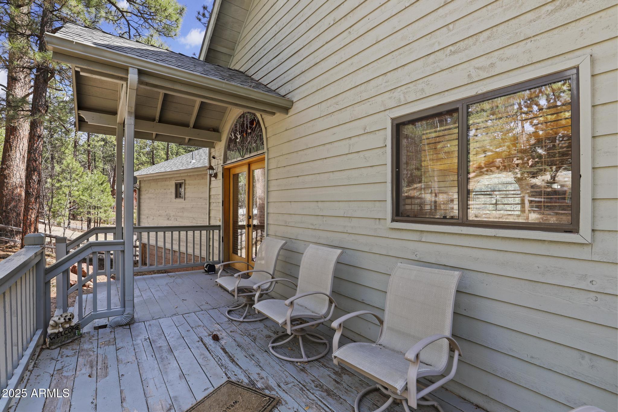 178 Memory Lane Payson, AZ 85541 - Photo 48 of 58 a view of a patio with table and chairs with wooden floor and fence