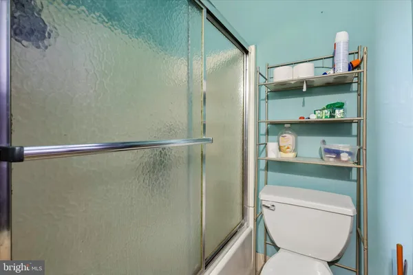 a bathroom with a toilet and a shower