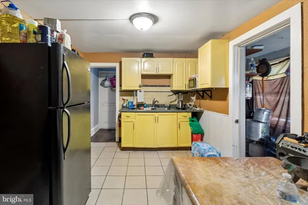 a kitchen with refrigerator and window