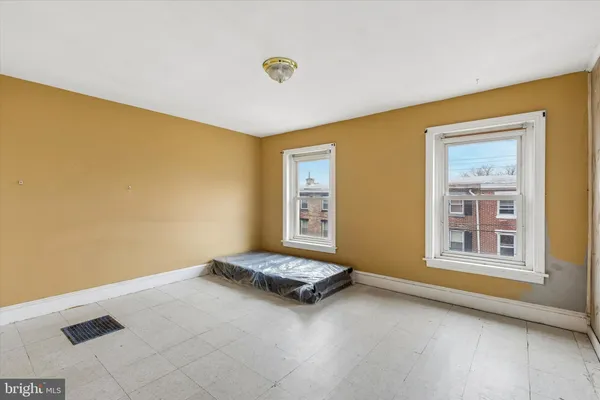 a living room with a bed furniture and a window