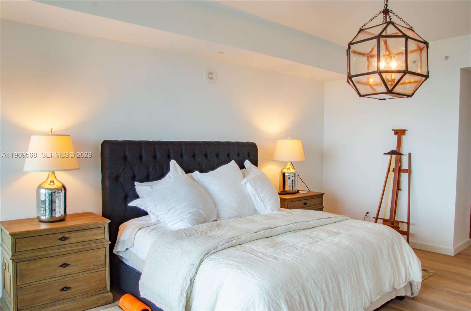 350 Ocean Drive, Unit 406N Key Biscayne, FL 33149 - Photo 27 of 41 a bedroom with a bed and a chandelier