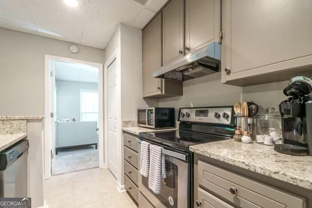 a kitchen with stainless steel appliances granite countertop a sink and a stove