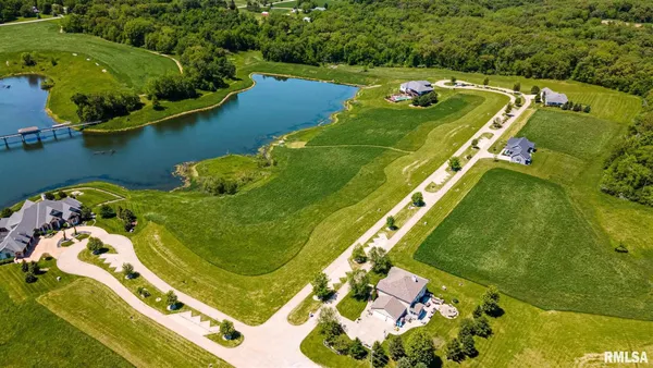 an aerial view of a pool a yard and front of tennis court