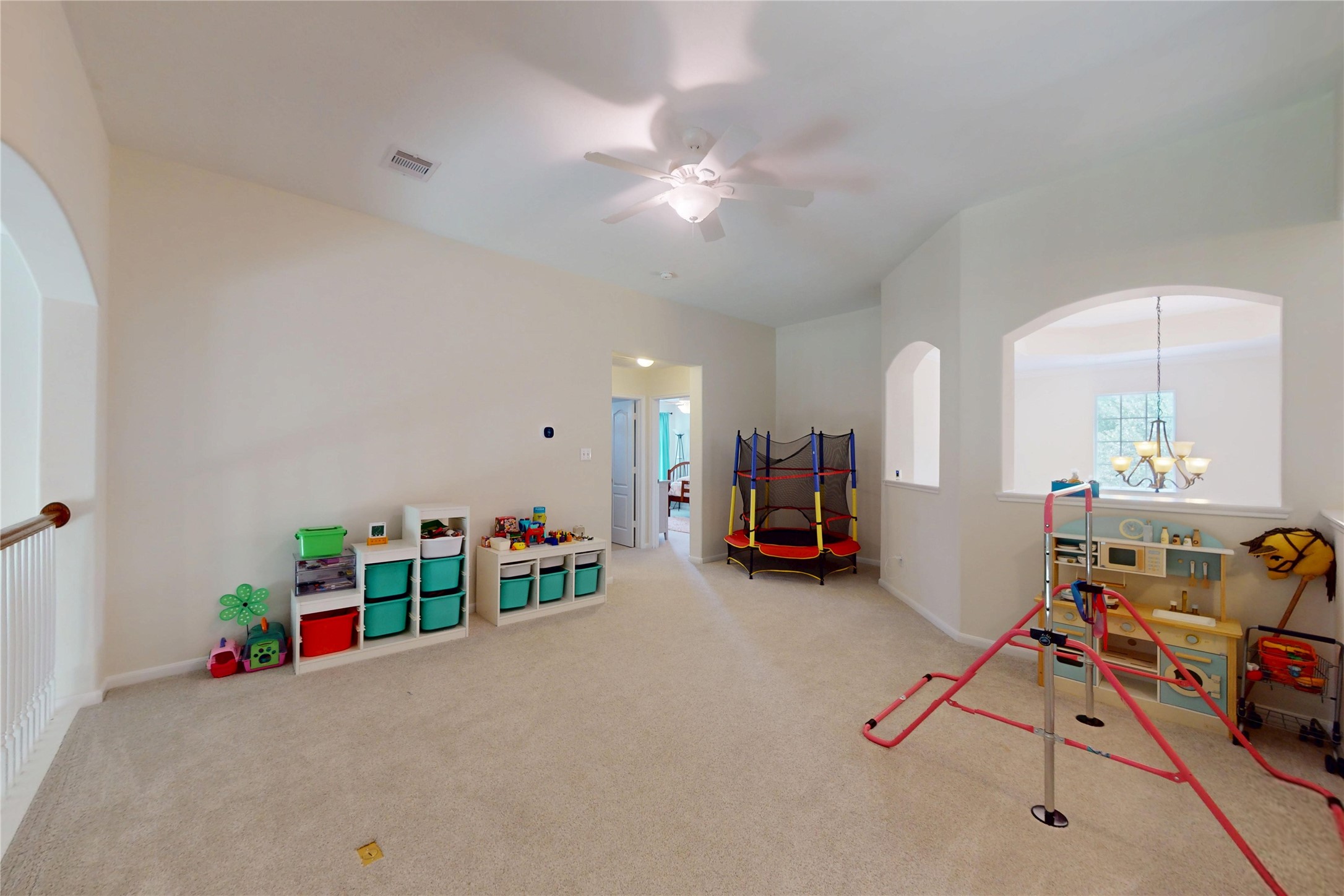 17402 Rainer Valley Lane Humble, TX 77346 - Photo 19 of 33 This spacious playroom features neutral carpeting, ample natural light, and room for shelving to keep organization. It's designed for family fun, with room for toys and activities, making it perfect for children.