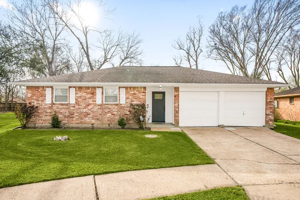 a front view of a house with a garden and yard
