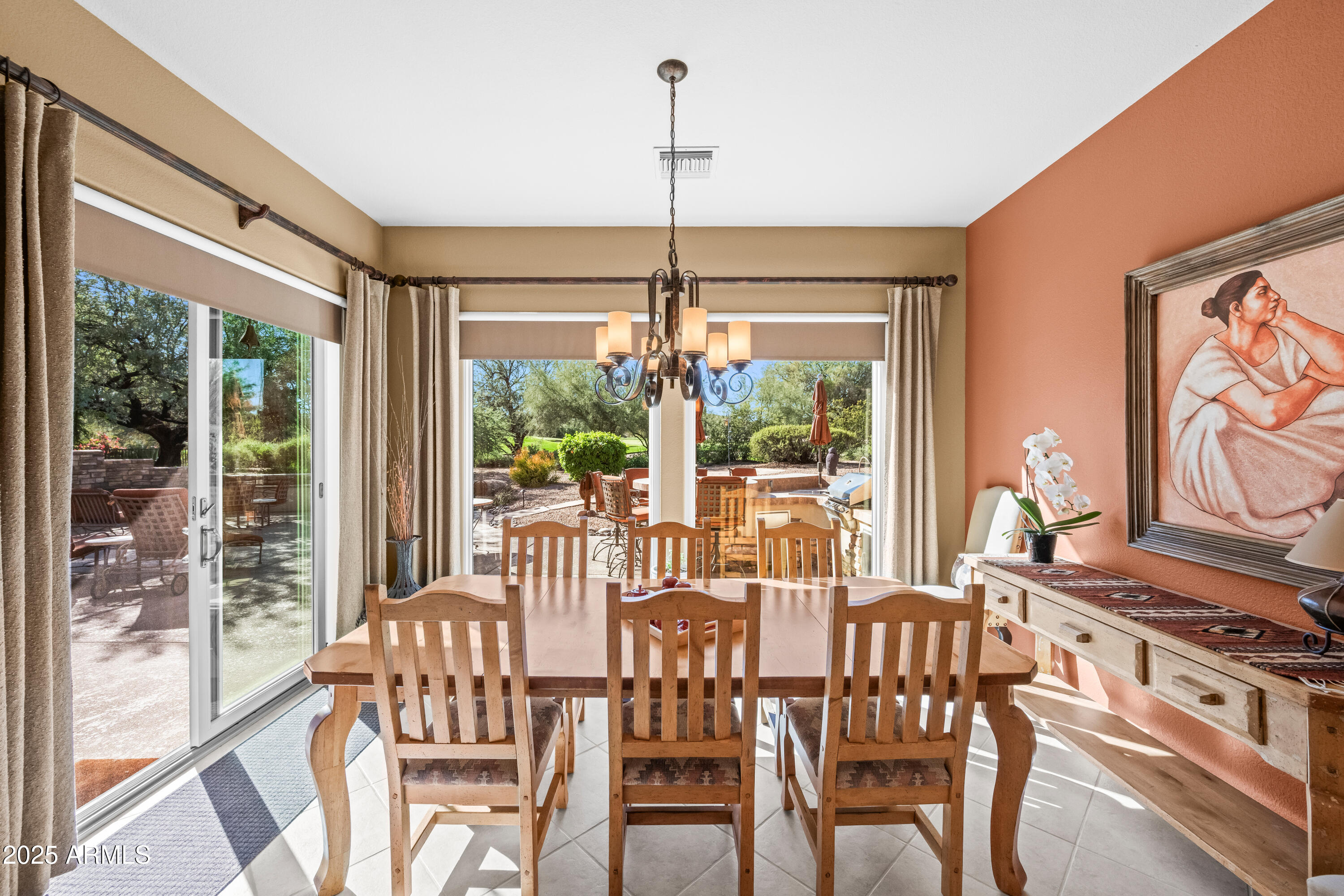 27408 North Agua Verde Drive Rio Verde, AZ 85263 - Photo 19 of 40 a view of a dining room with furniture large windows and wooden floor