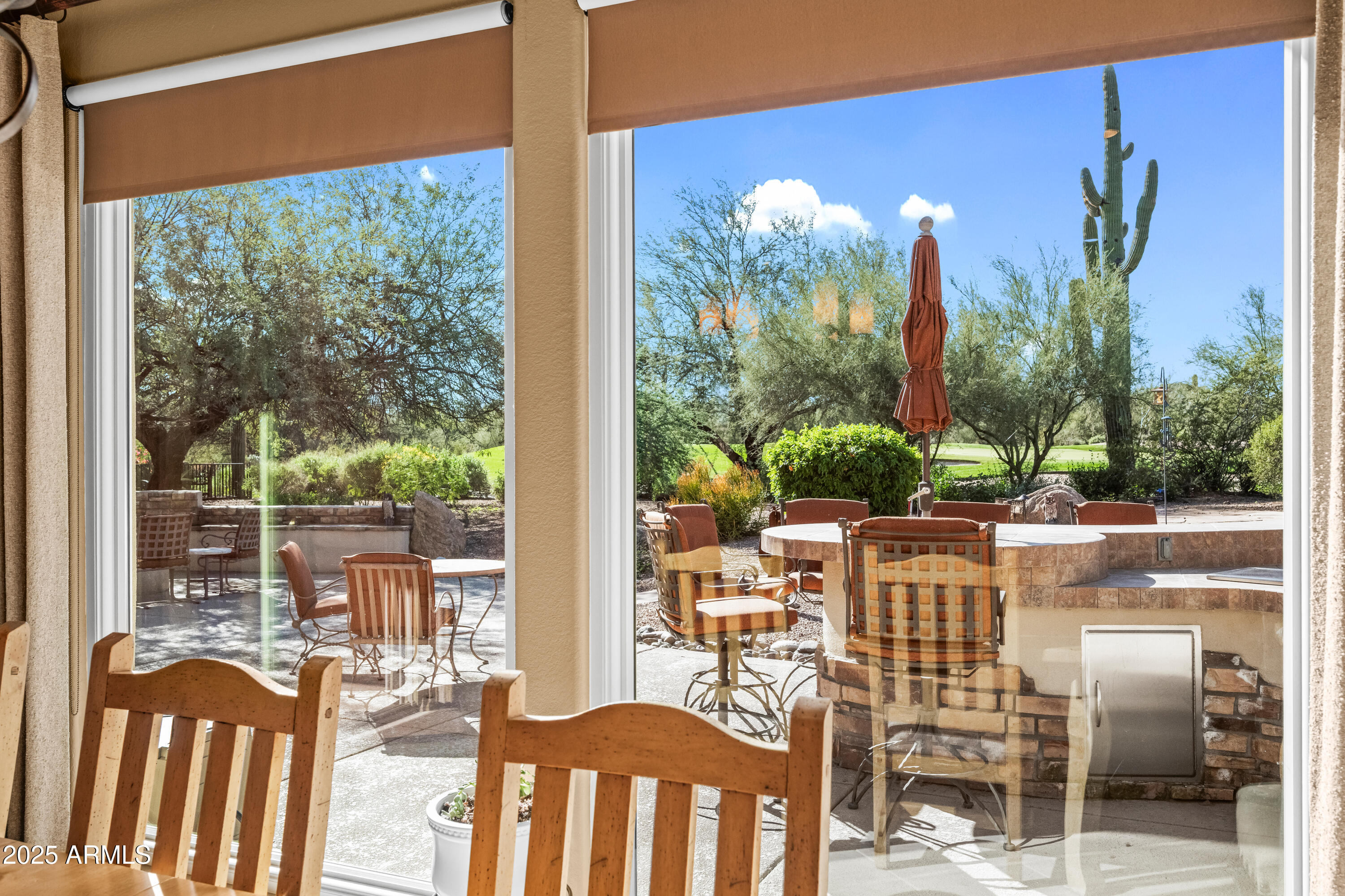 27408 North Agua Verde Drive Rio Verde, AZ 85263 - Photo 20 of 40 a view of a city from a dining room with large windows