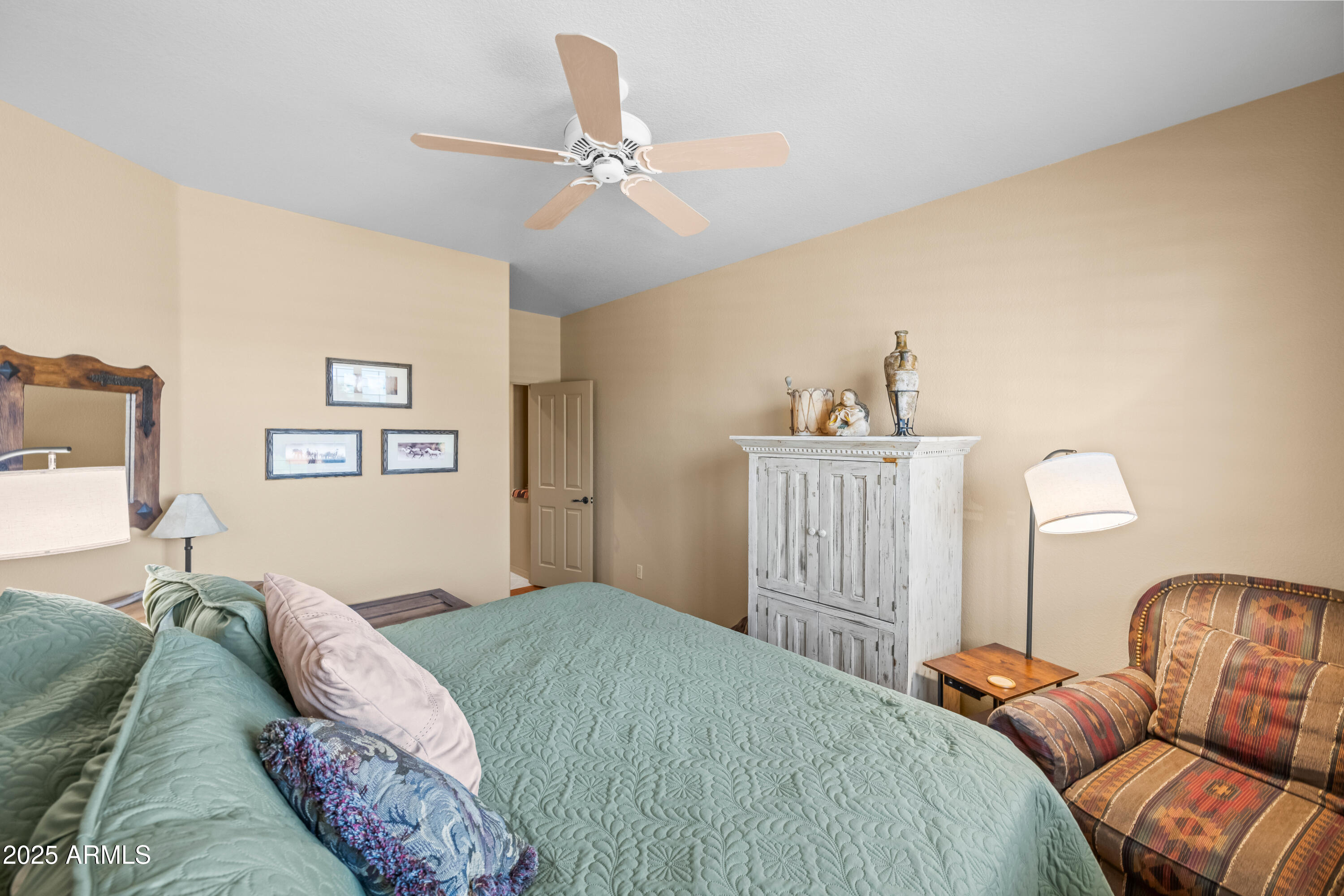27408 North Agua Verde Drive Rio Verde, AZ 85263 - Photo 26 of 40 a bedroom with a bed and a chandelier