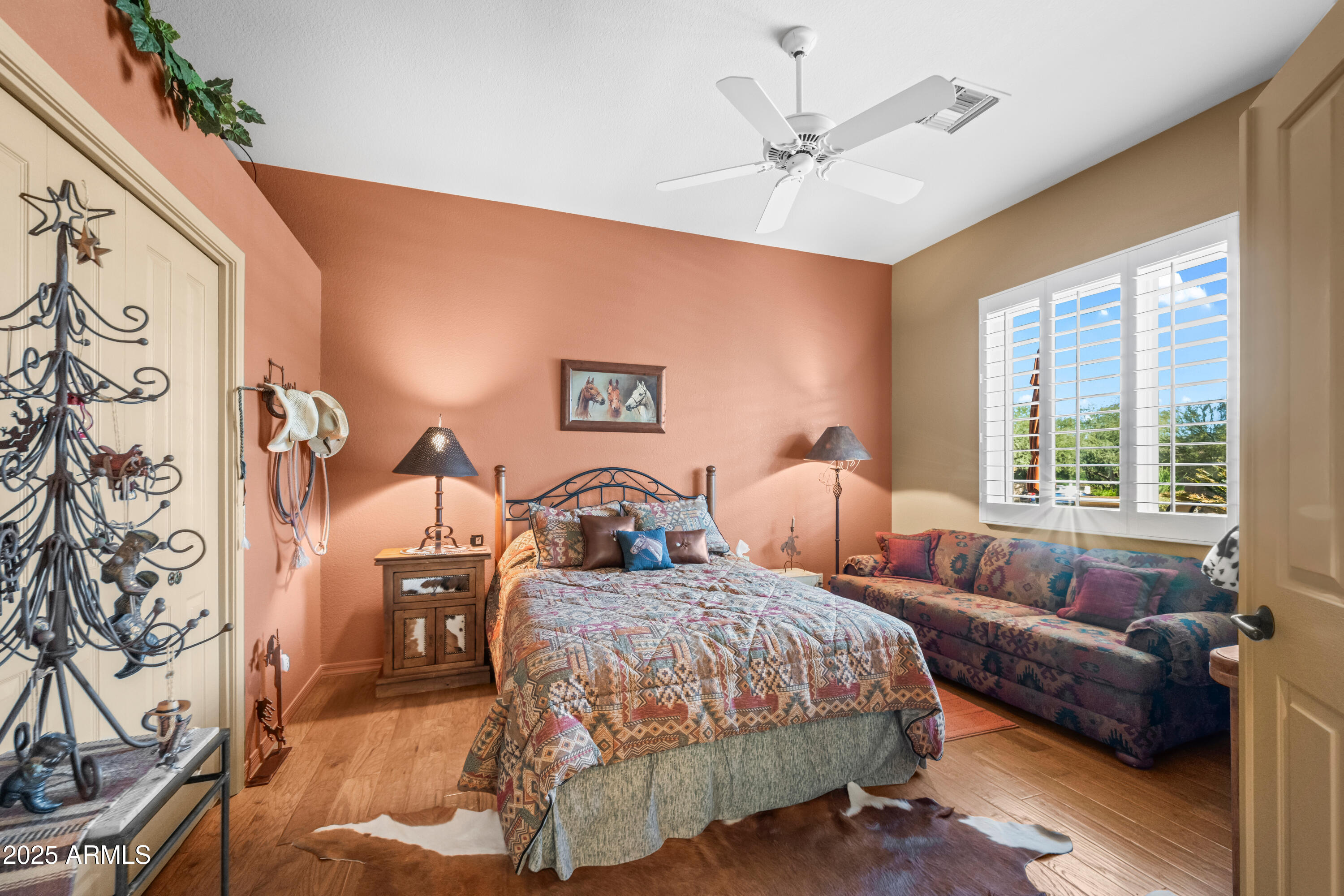 27408 North Agua Verde Drive Rio Verde, AZ 85263 - Photo 28 of 40 a spacious bedroom with a bed couches and a flat tv screen