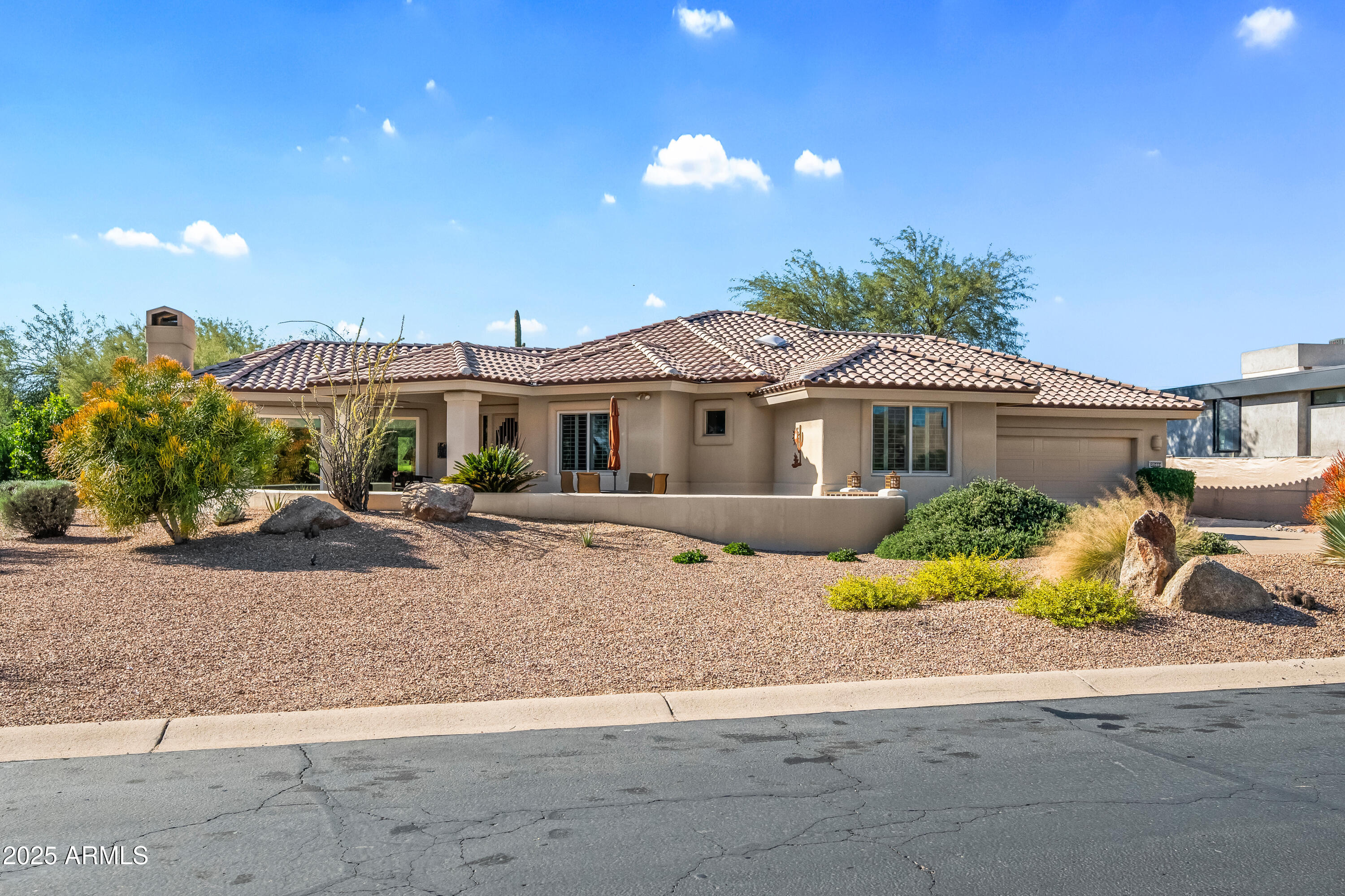 27408 North Agua Verde Drive Rio Verde, AZ 85263 - Photo 3 of 40 a front view of a house with a yard and a garage