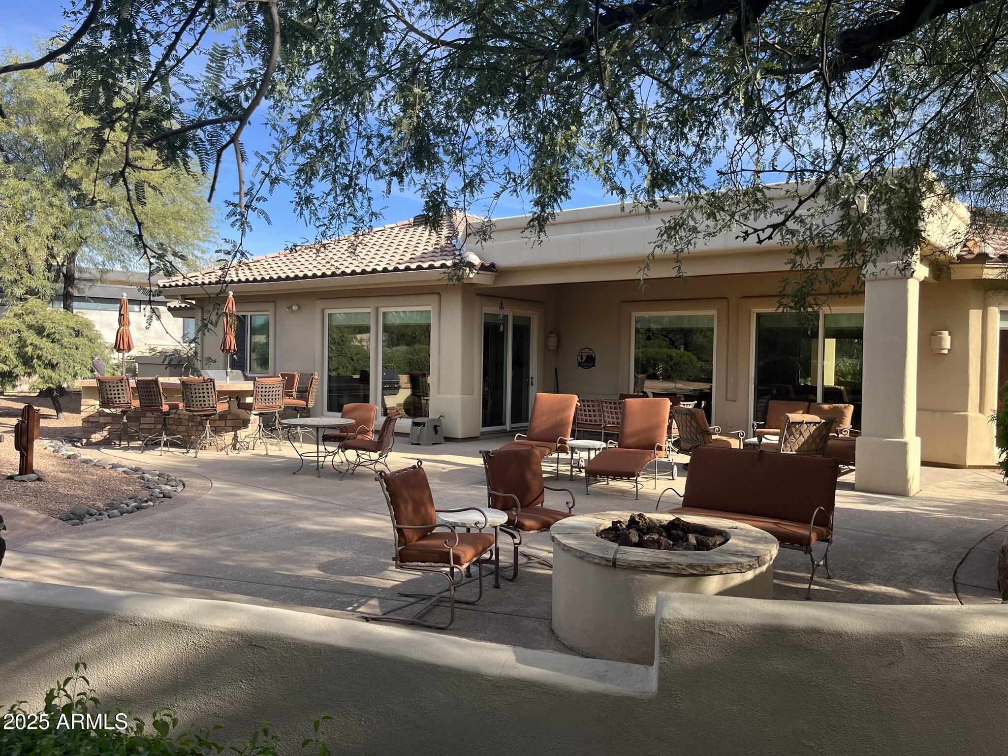 27408 North Agua Verde Drive Rio Verde, AZ 85263 - Photo 39 of 40 a view of a patio with couches table and chairs and potted plants