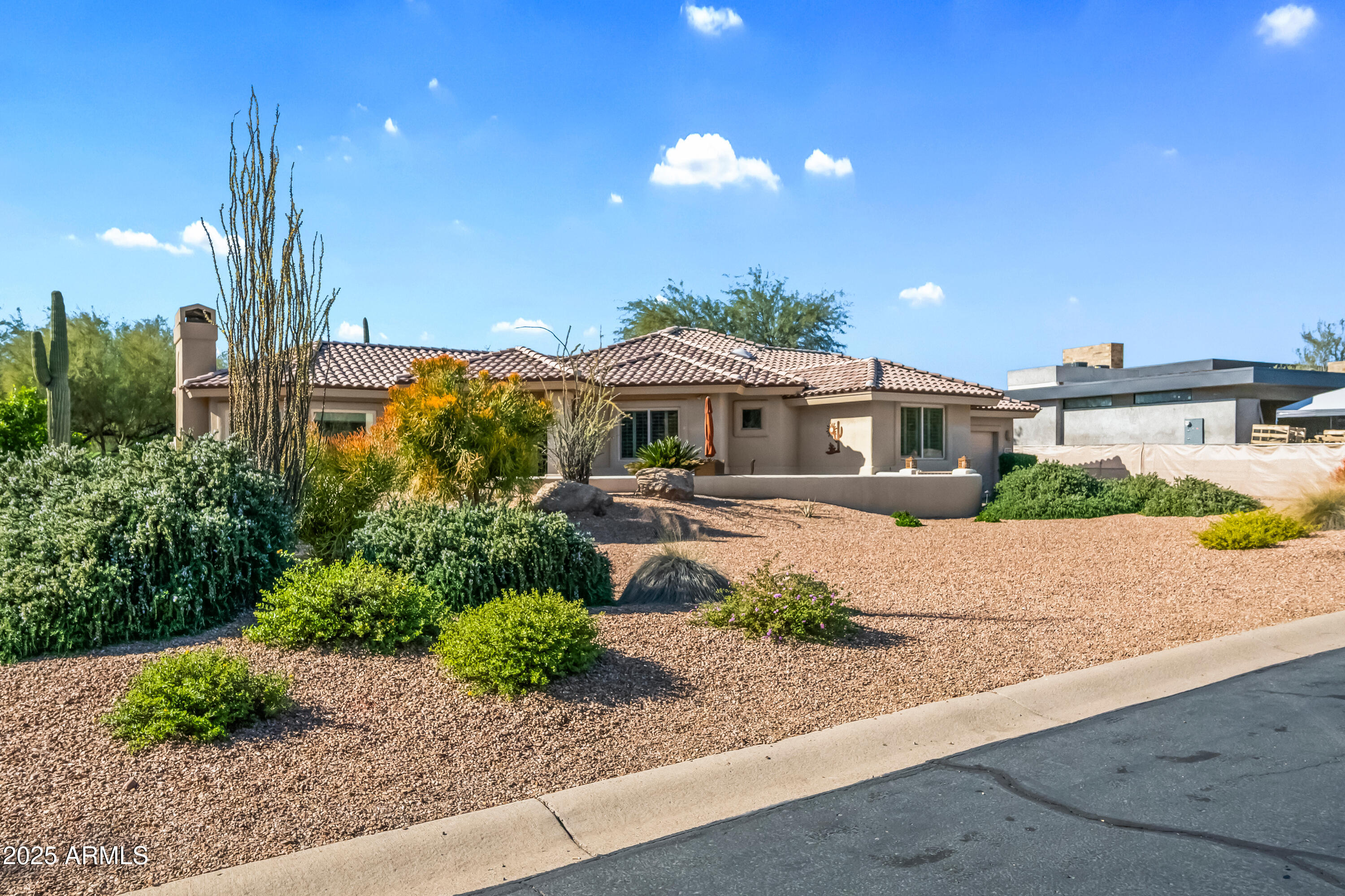 27408 North Agua Verde Drive Rio Verde, AZ 85263 - Photo 4 of 40 a front view of a house with a yard and potted plants