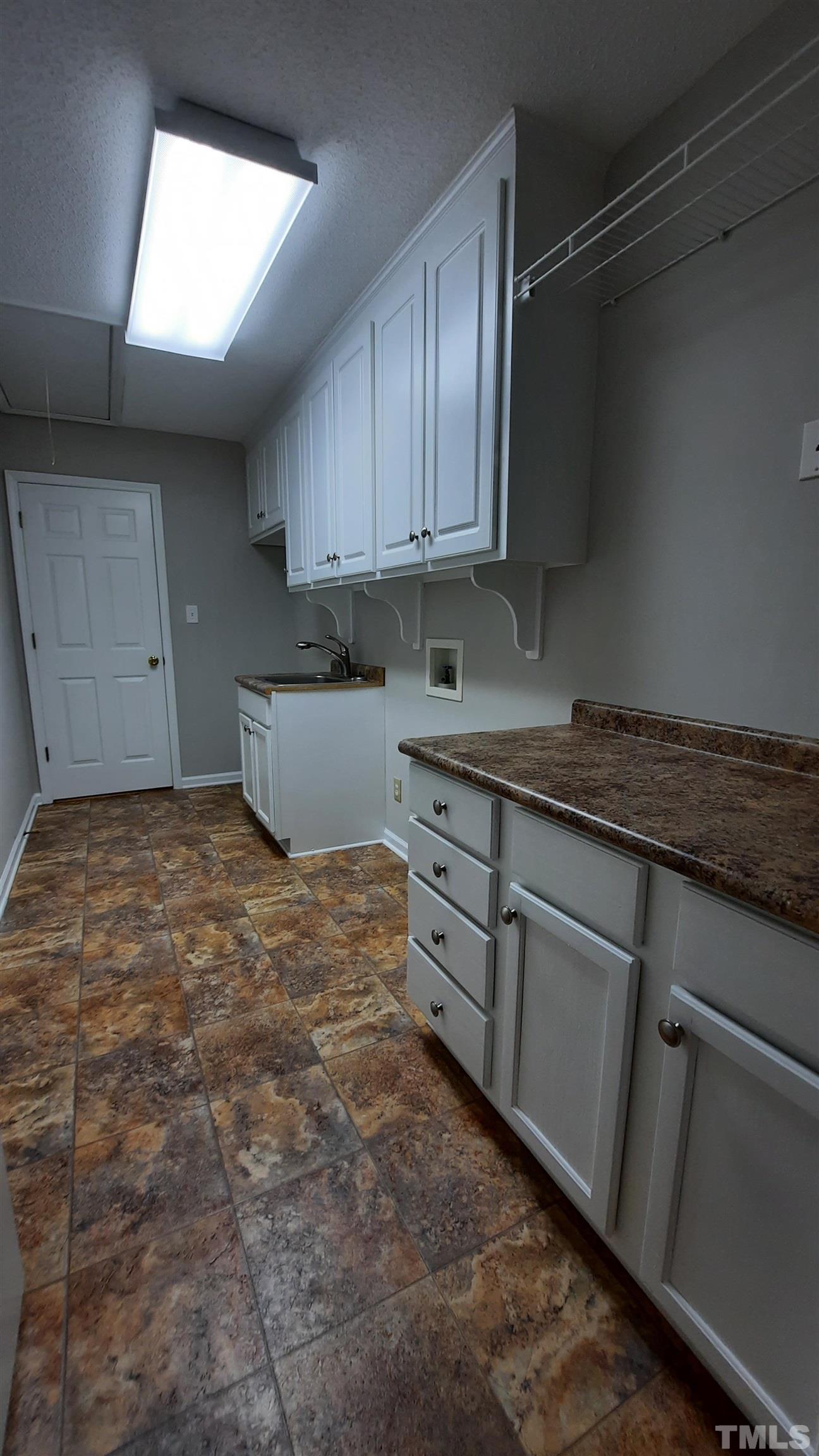 1909 Shaw Road Durham, NC 27704 - Photo 12 of 18 a room with cabinets and window