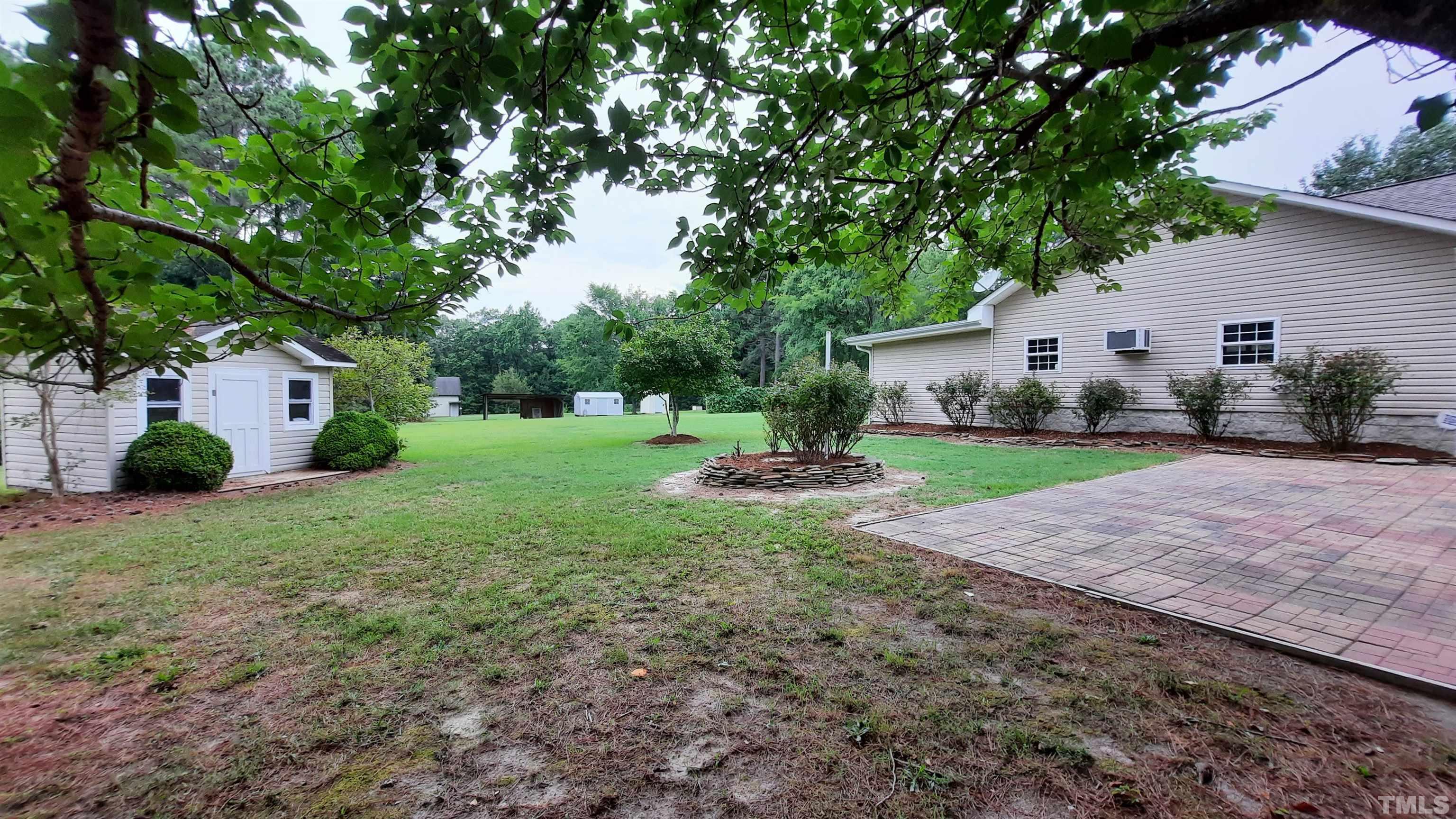 1909 Shaw Road Durham, NC 27704 - Photo 7 of 18 a view of a house with backyard and tree