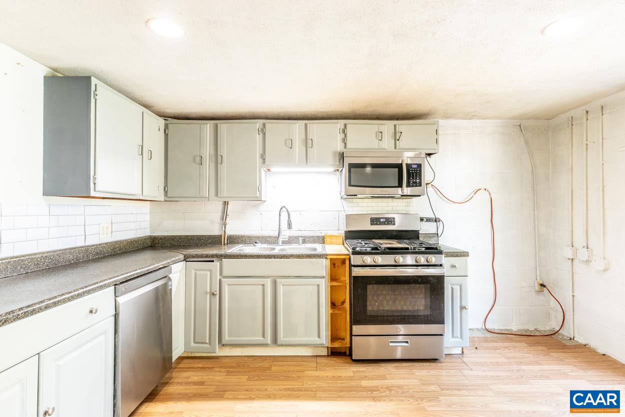 327 Village Road Shipman, VA 22971 - Photo 33 of 48 a kitchen with a stove a sink and a microwave