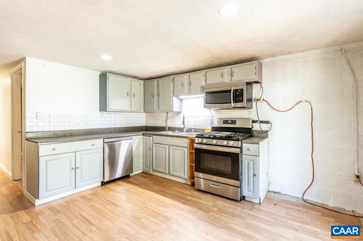 327 Village Road Shipman, VA 22971 - Photo 34 of 48 a kitchen with granite countertop a stove and a sink