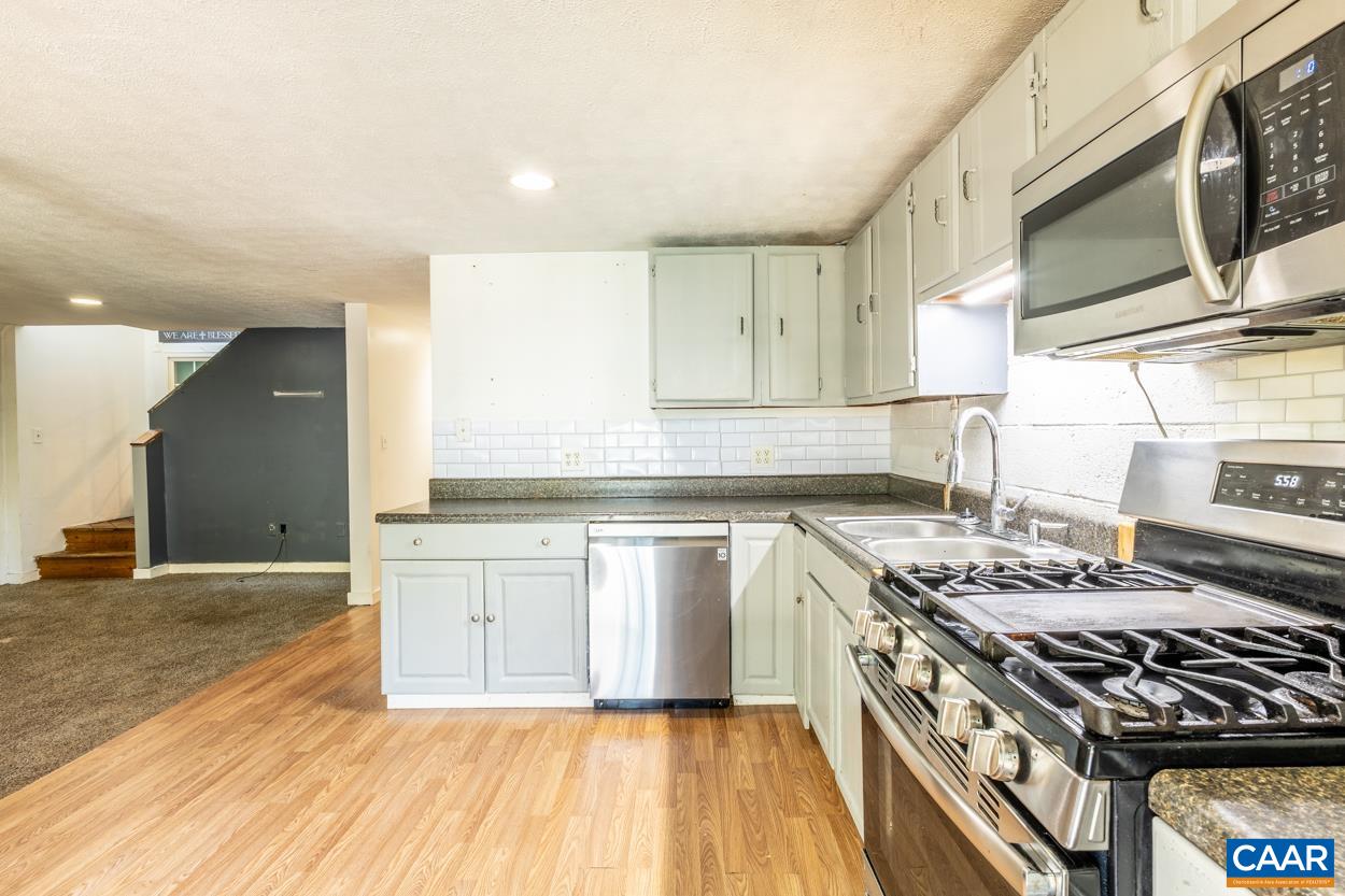 327 Village Road Shipman, VA 22971 - Photo 35 of 48 a kitchen with stainless steel appliances granite countertop a stove a sink and a microwave