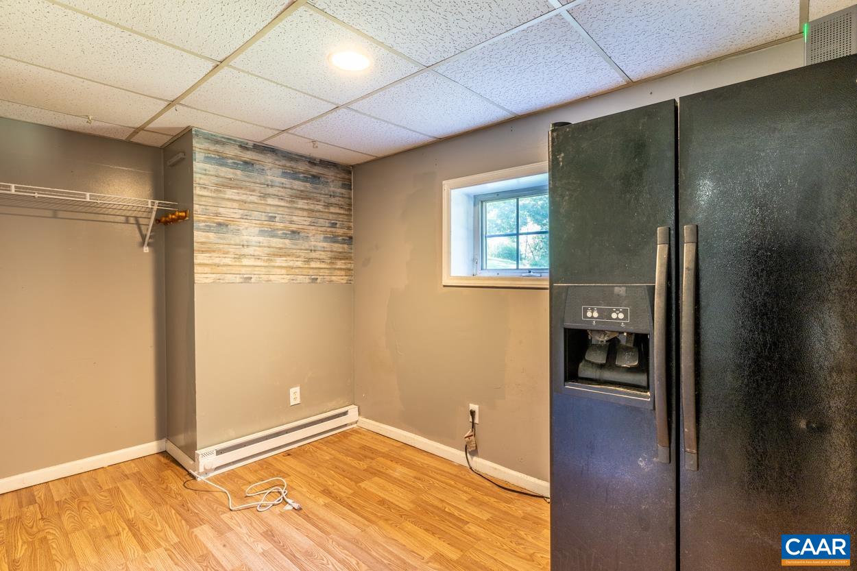 327 Village Road Shipman, VA 22971 - Photo 36 of 48 a view of an empty room with wooden floor and a bathroom