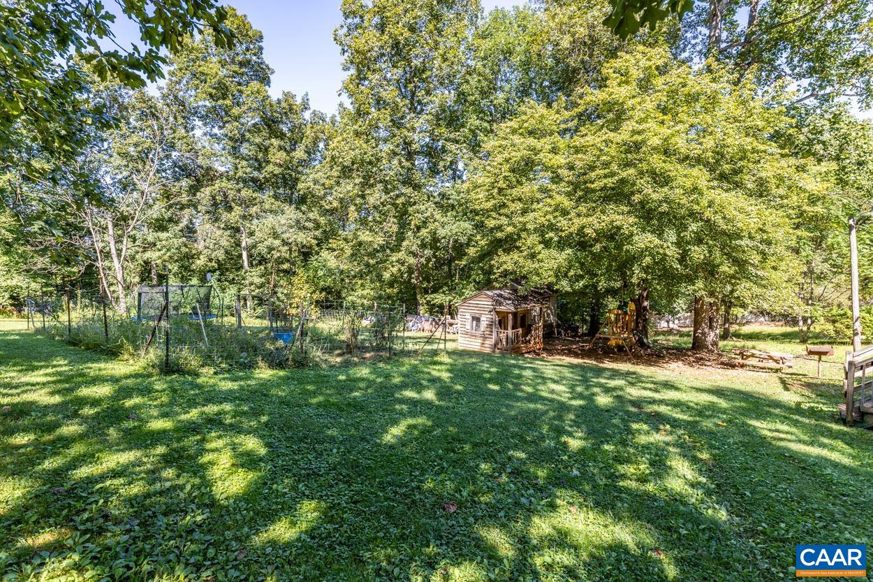 327 Village Road Shipman, VA 22971 - Photo 6 of 48 a backyard of a house with lots of green space and fountain