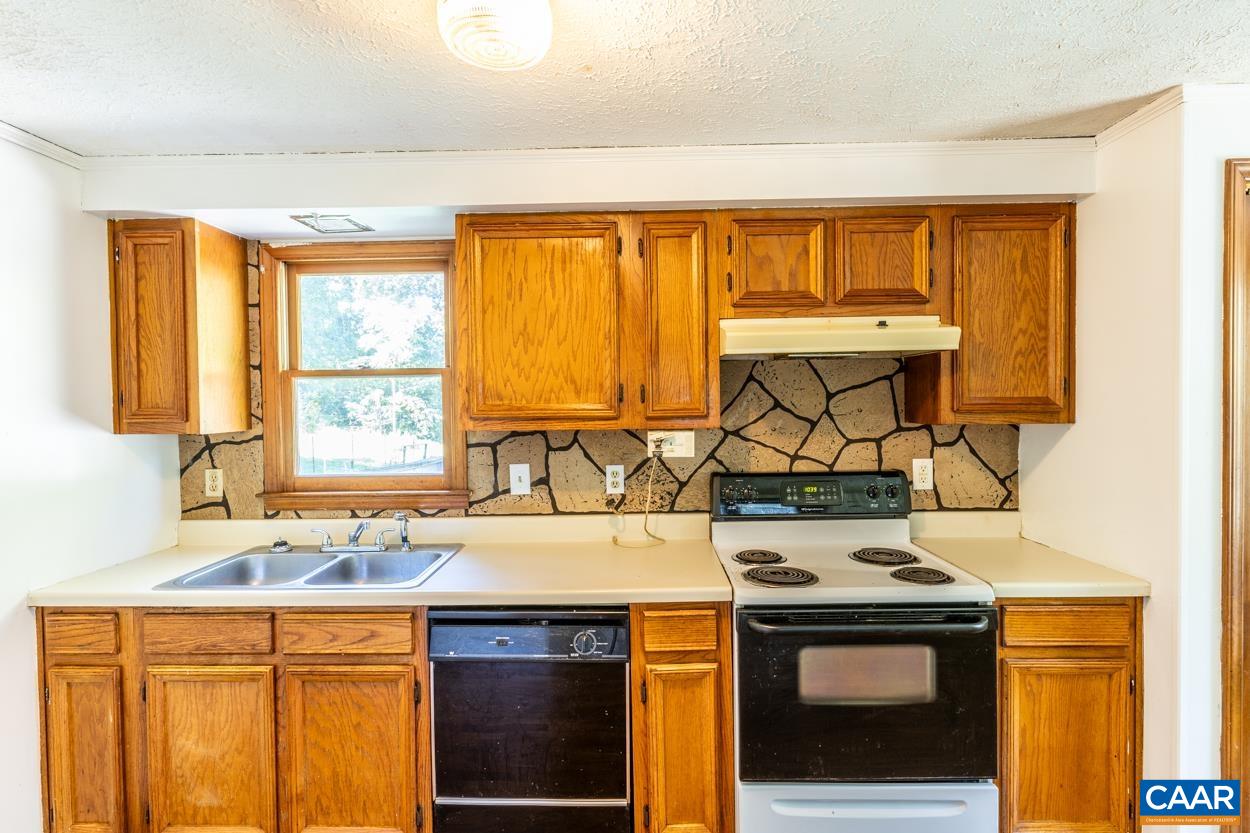 327 Village Road Shipman, VA 22971 - Photo 7 of 48 a kitchen with a sink stove and cabinets