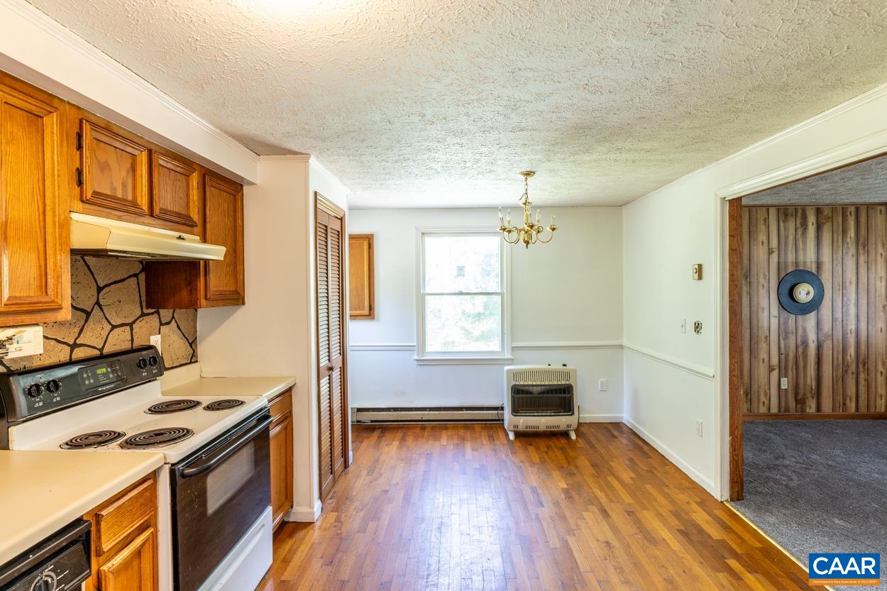327 Village Road Shipman, VA 22971 - Photo 8 of 48 a kitchen with a stove and wooden floor