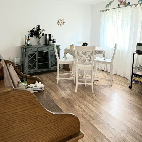 a dining room with furniture and wooden floor